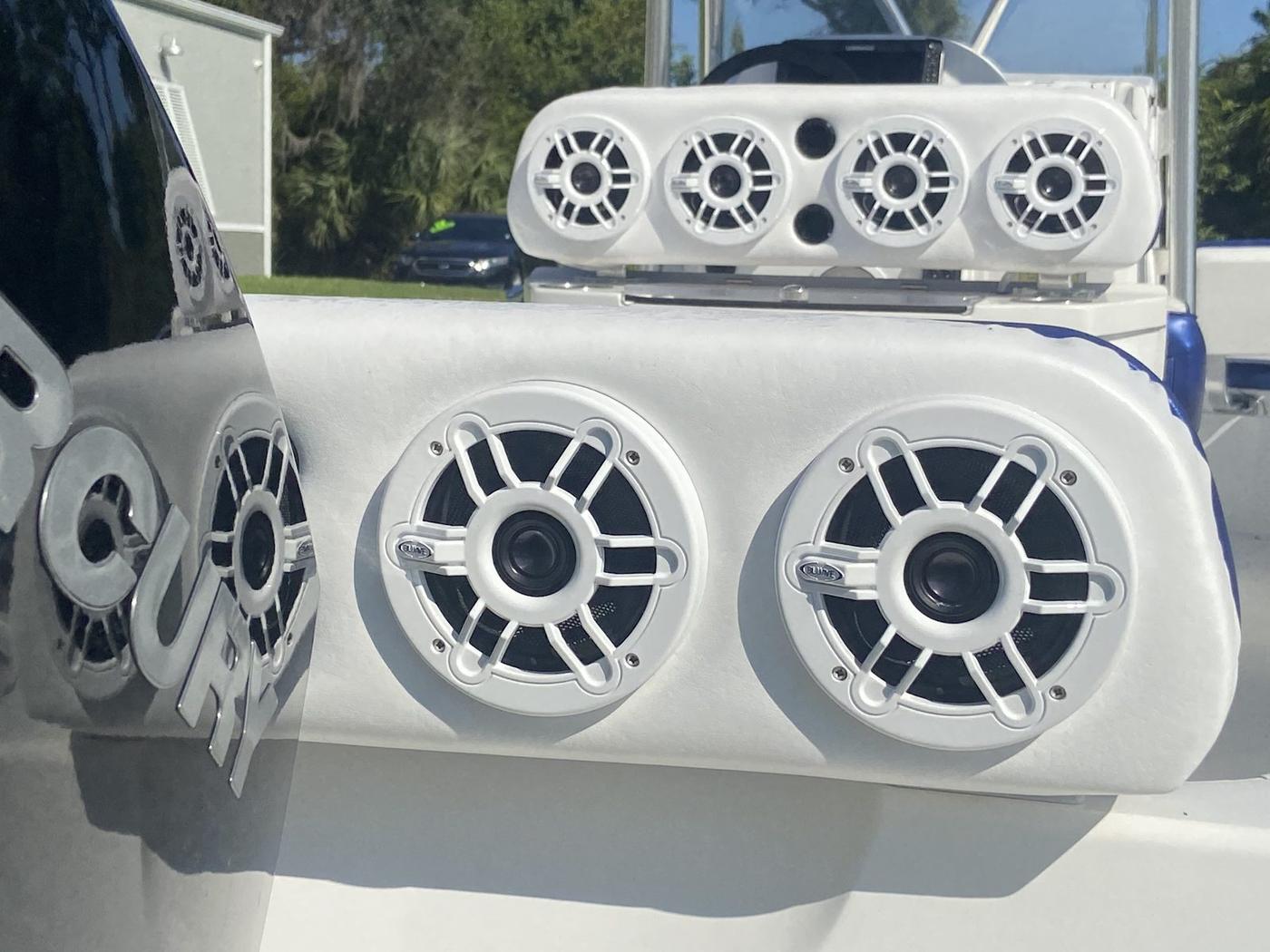 White marine speaker pods with multiple speakers on a center console boat