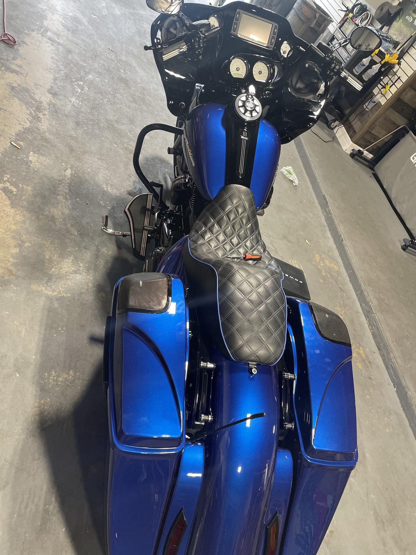 Blue Harley-Davidson Road Glide with saddlebag speaker lids and diamond-stitch seat