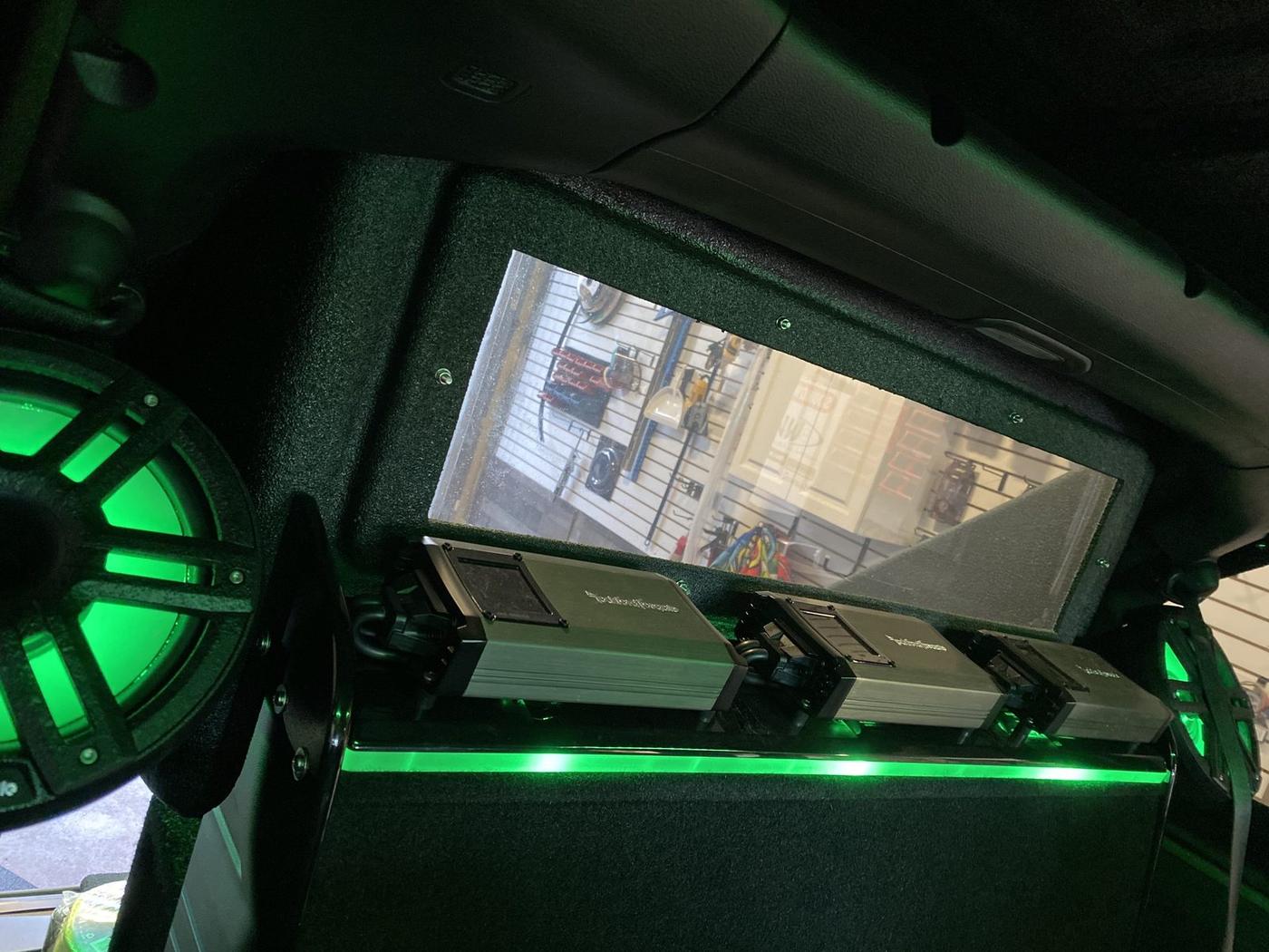 Vehicle interior audio install with green LED accent lighting