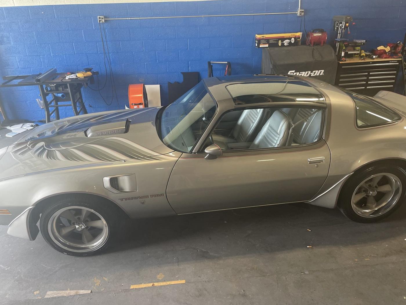 Silver Pontiac Trans Am in for audio work